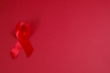 red ribbon symbol of World AIDS Day. Top view. Free copy space.