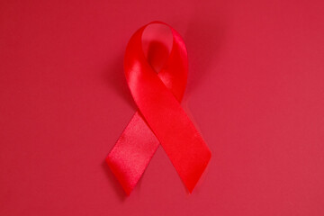 red ribbon symbol of World AIDS Day. Top view. Free copy space.