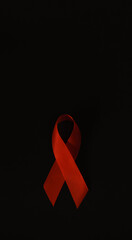 red ribbon symbol of World AIDS Day. Top view. Free copy space.
