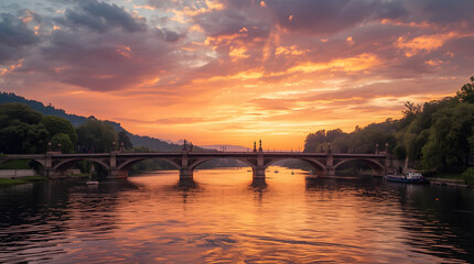 Majestic stone bridge with arched spans over calm river at fiery sunset, reflecting warm orange sky and green treelines