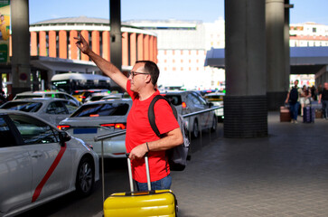 Man hailing taxi for urban travel at station