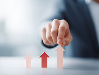 Business professional pointing at rising arrows to represent growth and success in a corporate setting