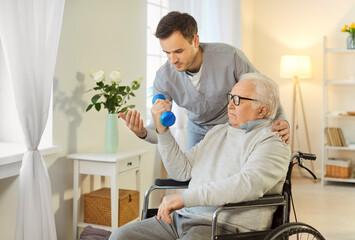 Doctor or nurse guiding an elderly man in a wheelchair through rehabilitation exercises using dumbbells at a nursing home. Therapy, strength training, and the importance of mobility and recovery.