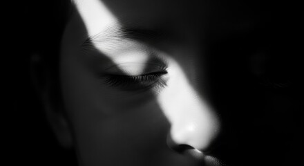 Closeup of a persons eye with dramatic light and shadow, conveying a sense of mystery and introspection