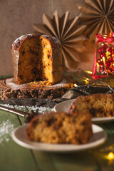 Vertical View of Panettone Cake with Foreground Served Slices