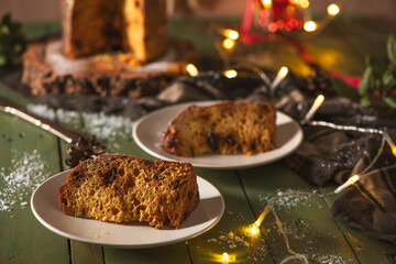 Two Slices of Panettone on Plates with Festive Holiday Decorations