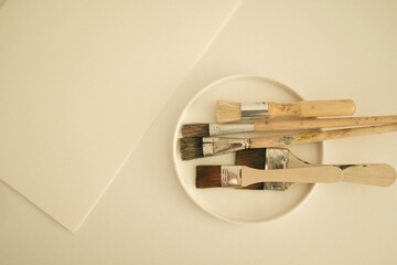 Clean old paint brushes for acrylic or oil painting. Starting a new creative project or artistic process, preparing to make a new DIY project or fine art painting. Blank canvas and clean palette. 