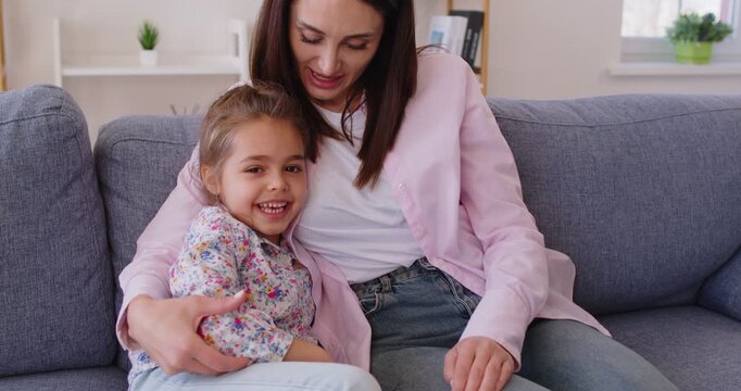 Mother and daughter cuddle at home, family love, happy motherhood emotion on Mother's Day, parent, child celebrate holiday enjoy time together, healthy understanding close hug, showing love, affection