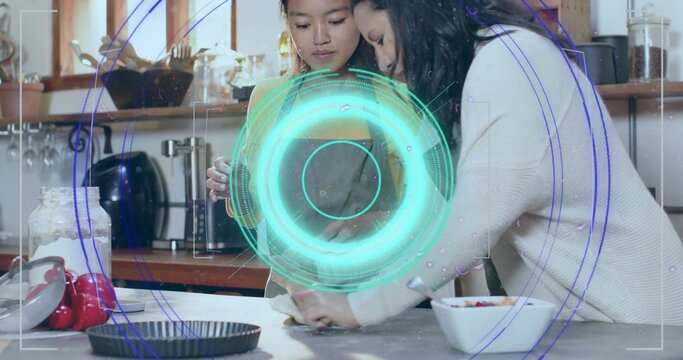 Preparing two women in apron and sweater shaping pastry dough on kitchen counter, with mixing bowl - Powered by Adobe