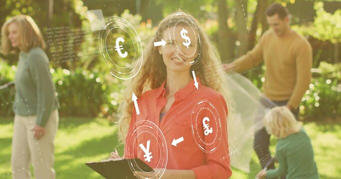 Holding clipboard and pen, woman in red shirt writing in backyard with HUD currency and blanket