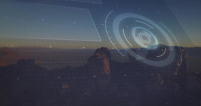 Fototapeta Towering rocky spires glowing in dusk sky at desert plateau with round reticle and grid overlay