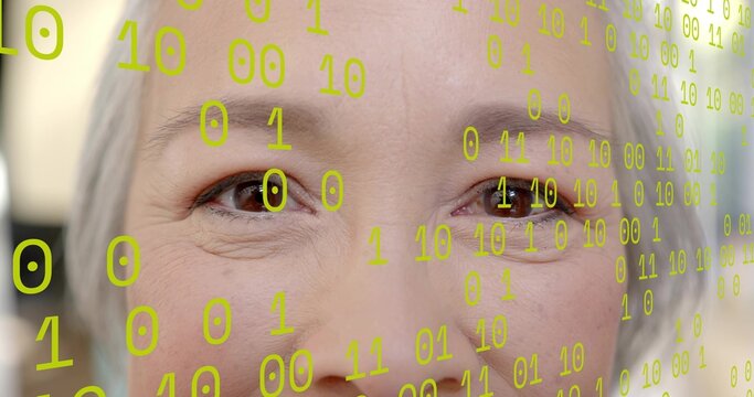 Gazing senior Asian woman showing facial texture and eyes in studio room, with neon binary overlay