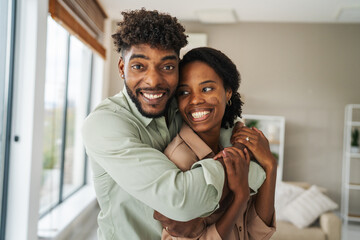 Obraz premium Happy black couple embracing at home