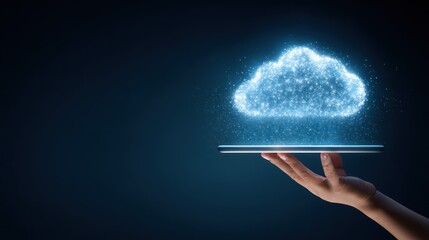 Hand holding tablet projecting glowing digital cloud data against dark background.