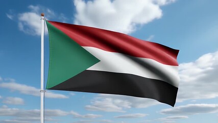 Vibrant Sudanese flag waves proudly in a gentle breeze against a bright blue sky with fluffy clouds, symbolizing national pride