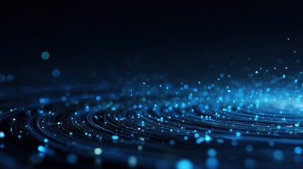 Abstract blue light trails and bokeh particles swirl in dark space.