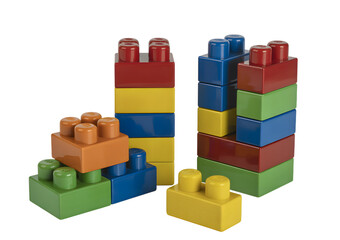 Fototapeta premium Colorful plastic building blocks stacked into towers for creative play and learning.