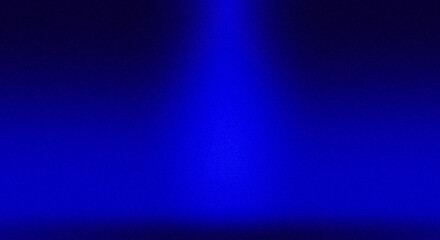 Intense, saturated deep blue background with a striking vertical spotlight beam from above. Dramatic setting for stage, performance, or cosmic themes.