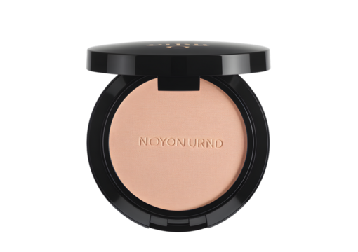 A close-up shot of a beige compact face powder in a sleek black case, with the brand name visible on the product.
