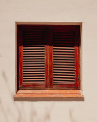 old window with red shutters, in northern Argentina.
