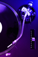 Turntable with black record and headshell. Neon tone