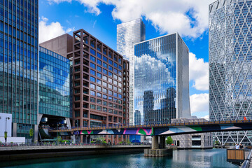 Canary Wharf, London UK, office buildings and Docklands Light Railway bridge