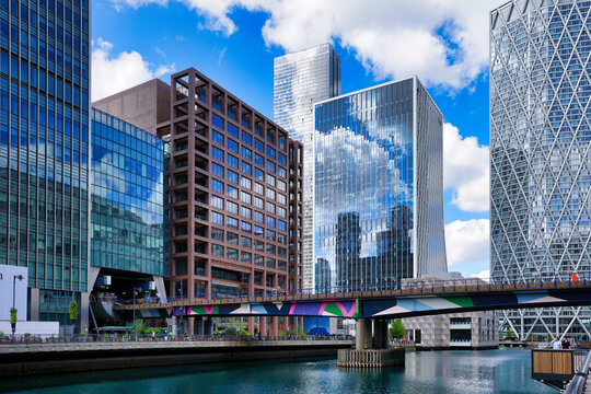 Canary Wharf, London UK, office buildings and Docklands Light Railway bridge