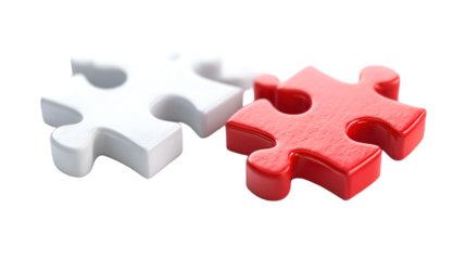 Two interlocking puzzle pieces one white and one red symbolizing connection and problem solving against a black background