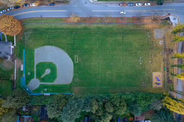 Aerial View Of A Baseball Field In A Park With Green Grass And Fall Foliage