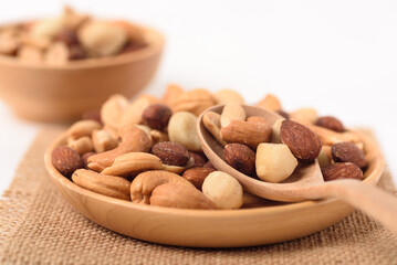 Mixed nuts consisting of almonds, cashews and peanuts, roasted with salt. Healthy snack on white background.