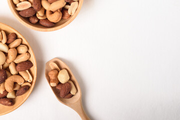 Mixed nuts consisting of almonds, cashews and peanuts, roasted with salt. Healthy snack on white background.