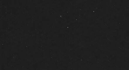 A dark background speckled with numerous small white dots, resembling stars in the night sky