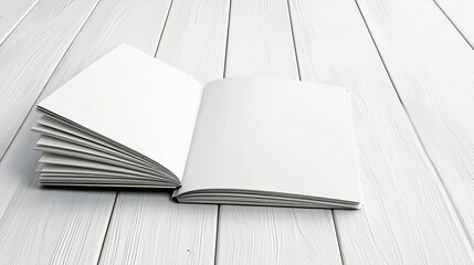 An open blank book with white pages rests on a white wooden surface, ready for content.