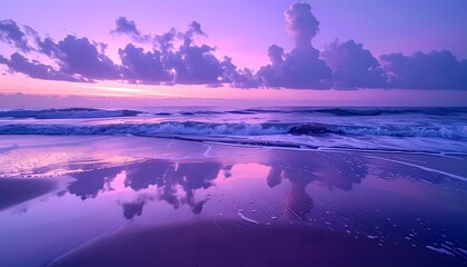 Vibrant purple and pink sunset over a tranquil ocean beach with reflections.