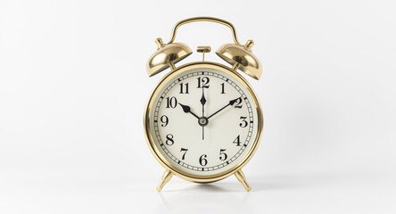 Classic golden alarm clock displaying ten past ten, symbolizing time management, deadlines, and the urgency of schedules for business and personal organization