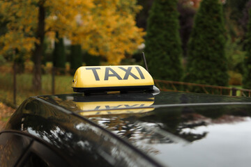 Yellow taxi sign on the roof of a car. Yellow taxi lamp. Taxi car.