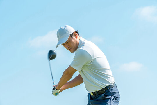 Male golfer playing golf on a golf course (tee shot, golf competition)
