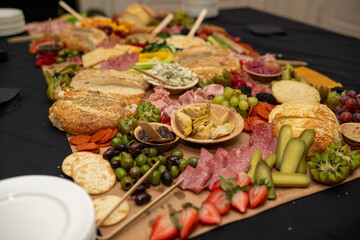 Large Charcuterie Board at an event with variety of finger foods