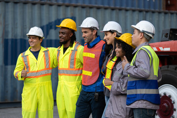 Group of diverse industrial workers standing confidently in front of cargo containers, symbolizing teamwork, diversity and professionalism in logistics and global shipping operations.