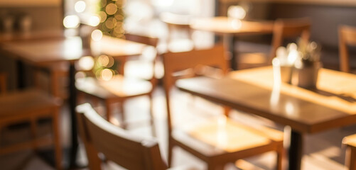 Blurred cafe interior with warm lighting, wooden textures, and soft focus. Modern seating area and decorative elements, suitable for lifestyle and creative backgrounds.