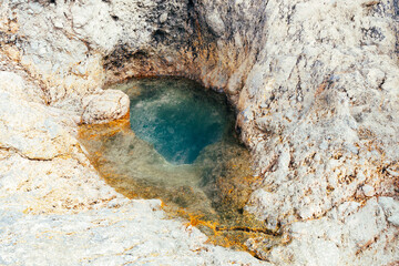 Beautiful view of a natural crack in the rock filled with water.