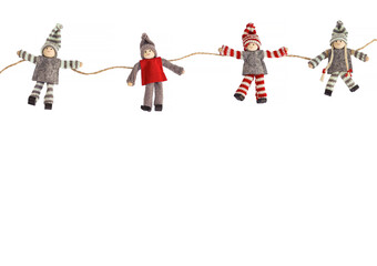 Holiday knitted dolls garland on white background. High quality photo