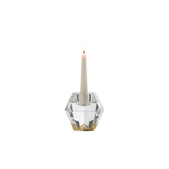 Isolated burning candle and candlestick on a white background symbolizing light, celebration, or religion