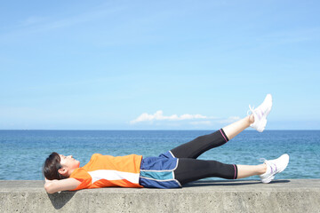 海辺でストレッチをする女性