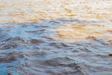 Meeting of waters Rio Negro and Amazon River Amazonas Brazil.
