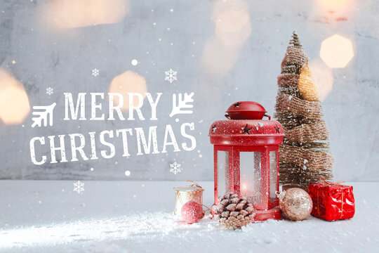 Christmas composition with red lantern, pine tree and holiday decorations on snowy background. Festive winter greeting card, seasonal design and Merry Christmas message.