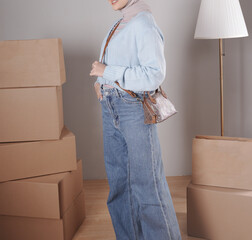 Young woman's body in a knitted sweater and jeans wearing a beautiful snakeskin bag