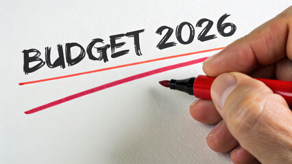 Budget 2026 financial goals business goals finance planning hand writing with red marker underlining emphasis on targets and investment decisions encouraging focus and confidence