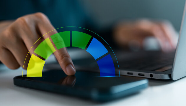 Hand using smartphone and laptop with performance meter. Productivity indicator tracking, digital progress analysis, data analytics and evaluation technology performance monitoring in modern business.