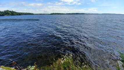 Speedboat Crossing Vast Blue Lake Shore
